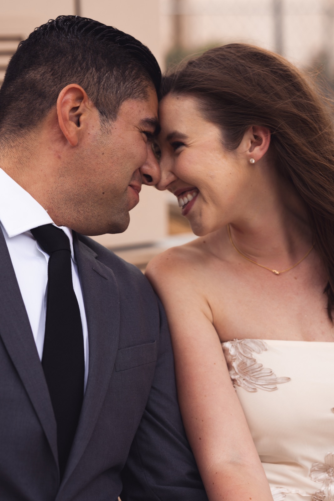 A couple sharing a close moment against a brick wall