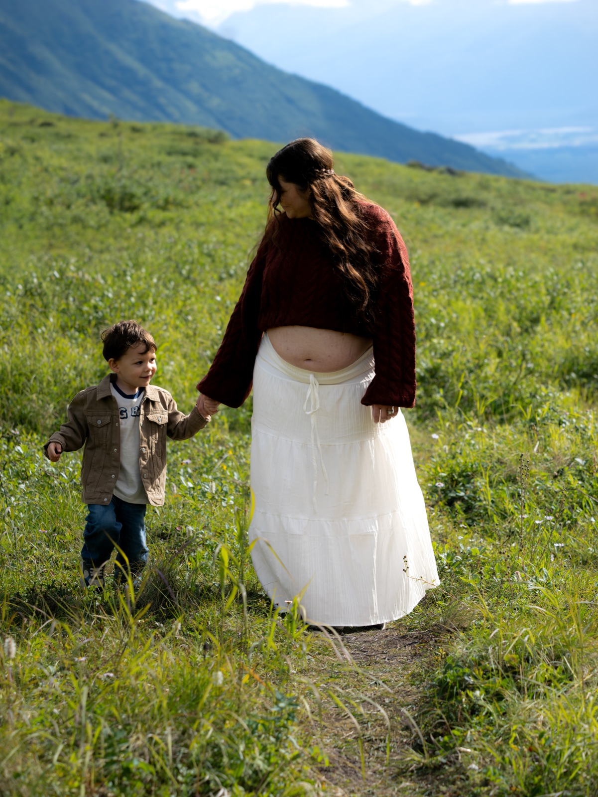 A mother and child in a mountain meadow