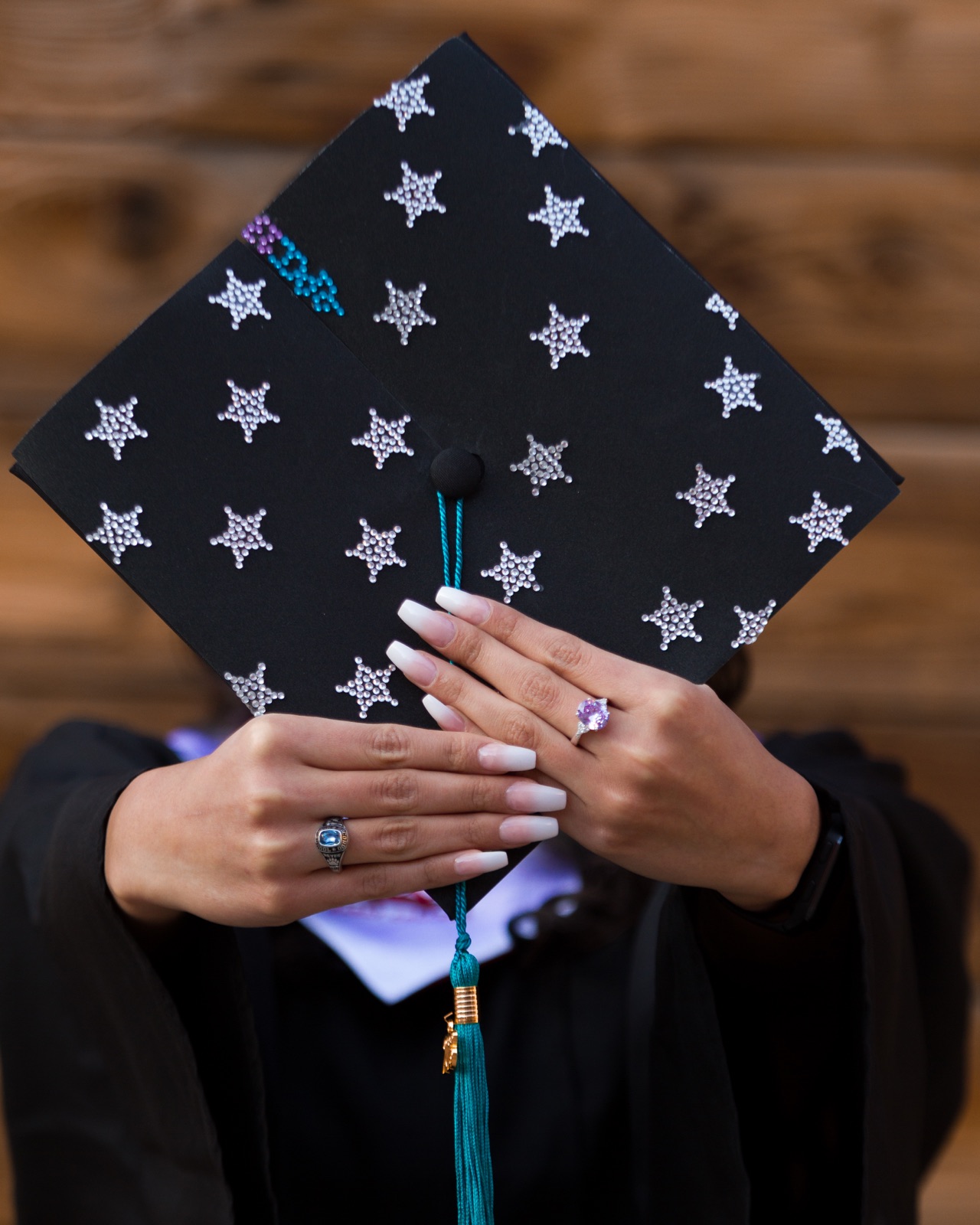 A decorated graduation cap held close