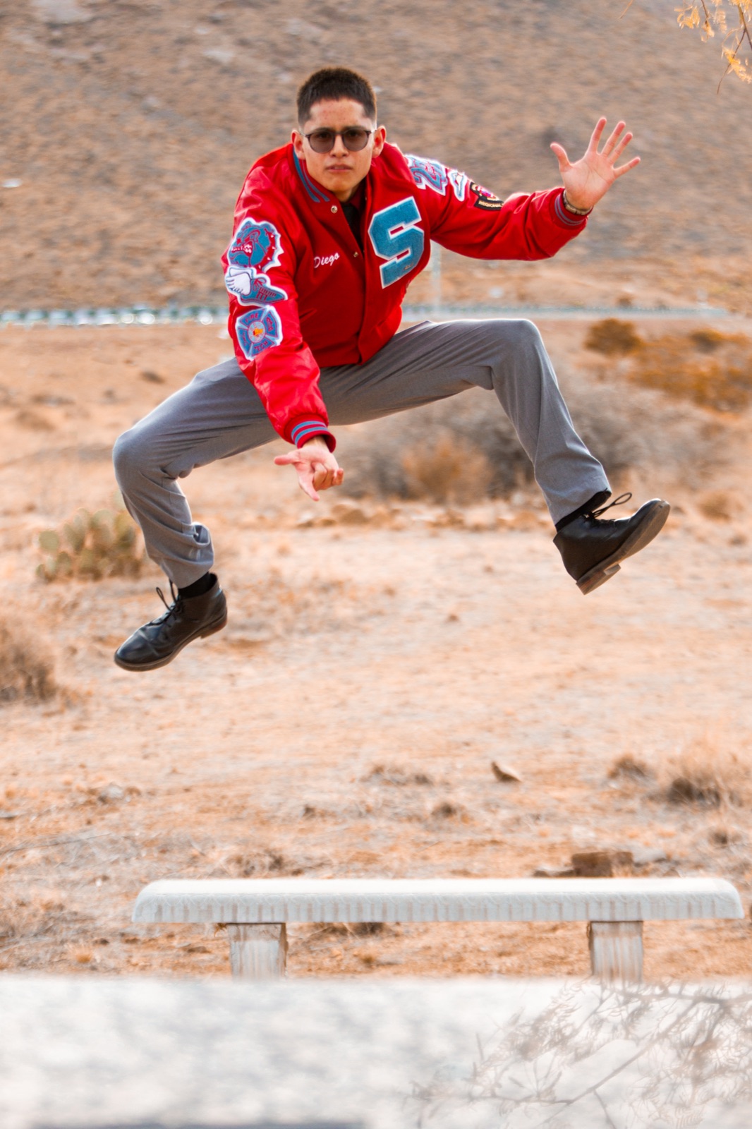 A graduate celebrating beside stone steps