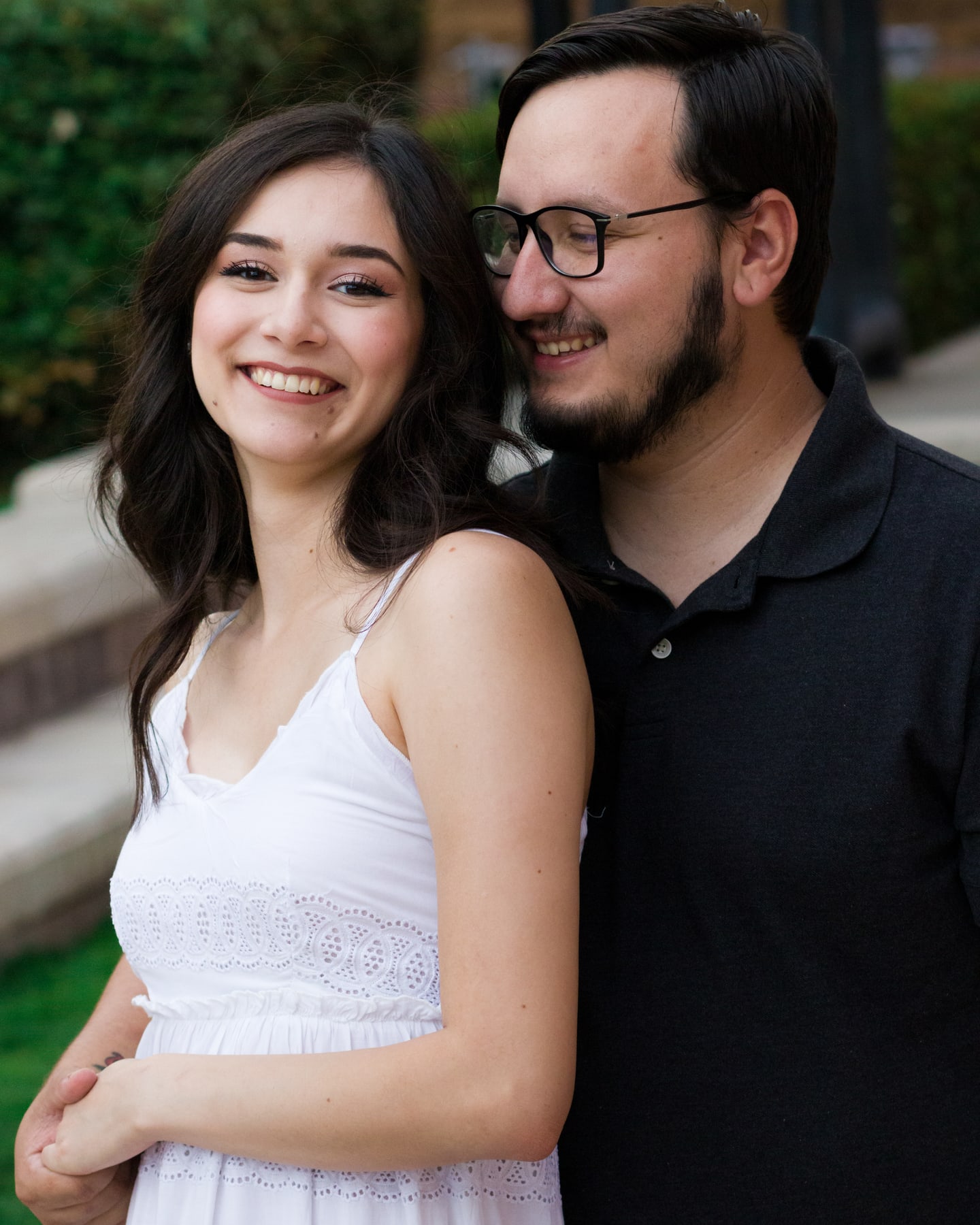 A close portrait of an engaged couple smiling together