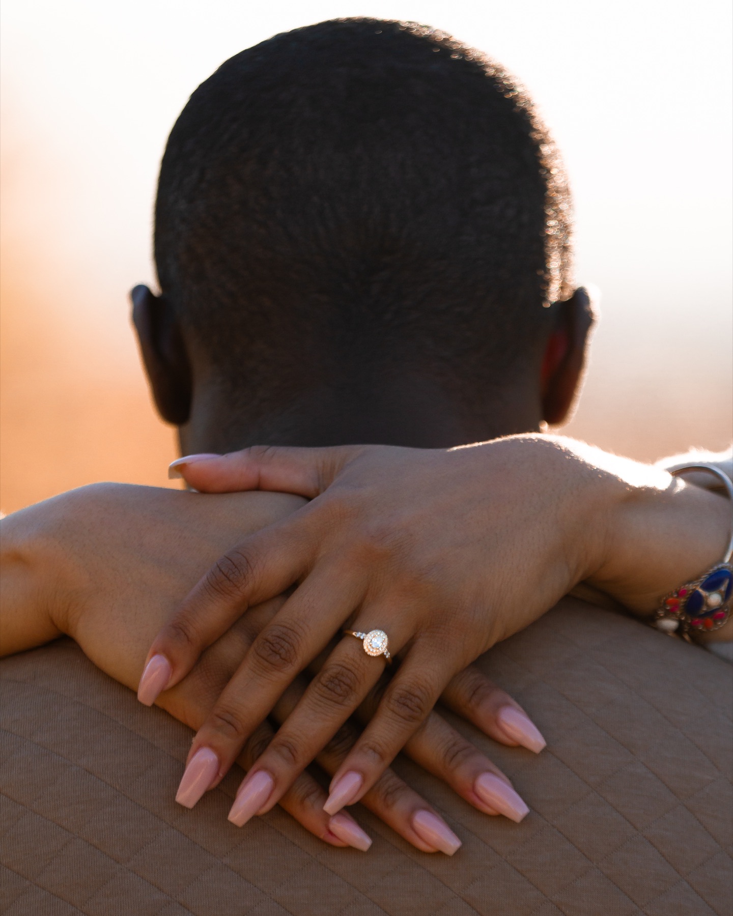 Jordin’s engagement ring visible during a hug with Ayo