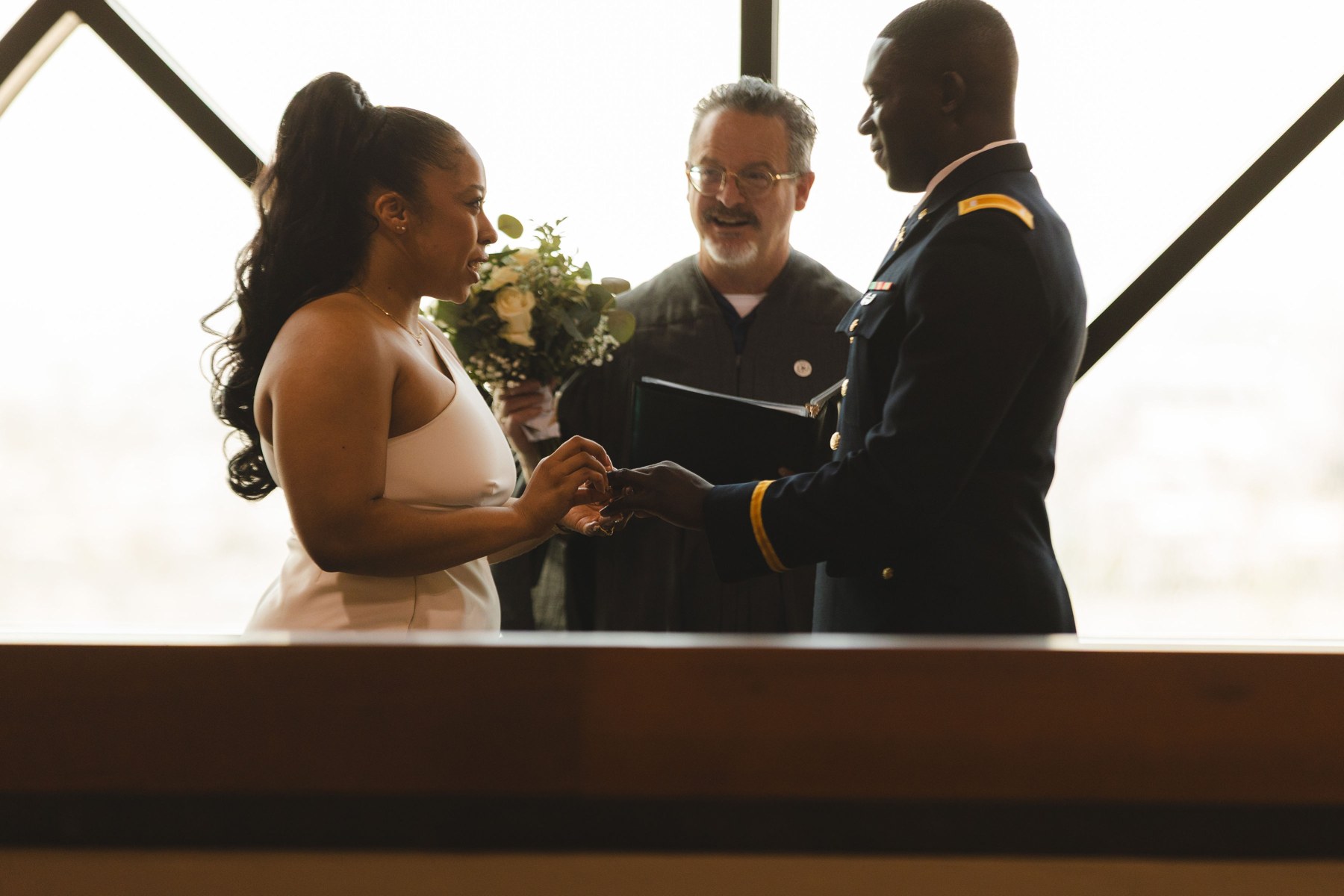 Jordin and Ayo exchanging rings during their ceremony
