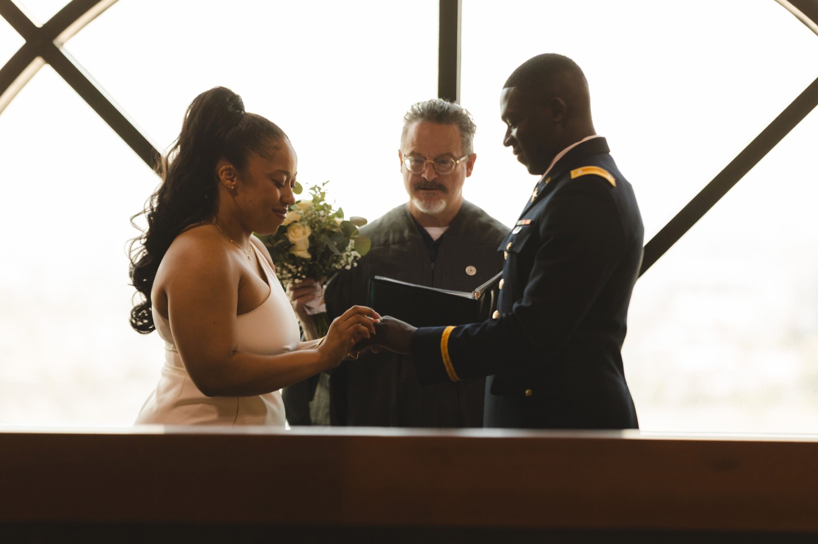 A couple exchanging vows at a courthouse
