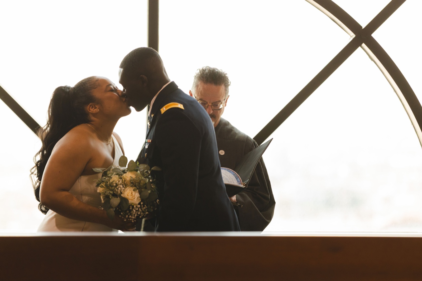 A couple sharing their first kiss during a ceremony