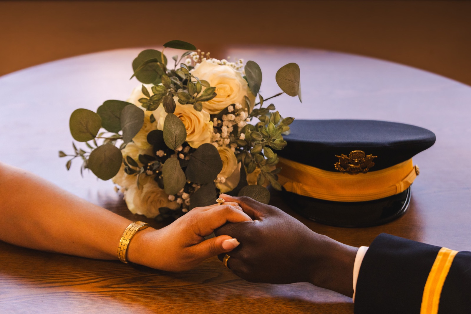 Wedding flowers and joined hands